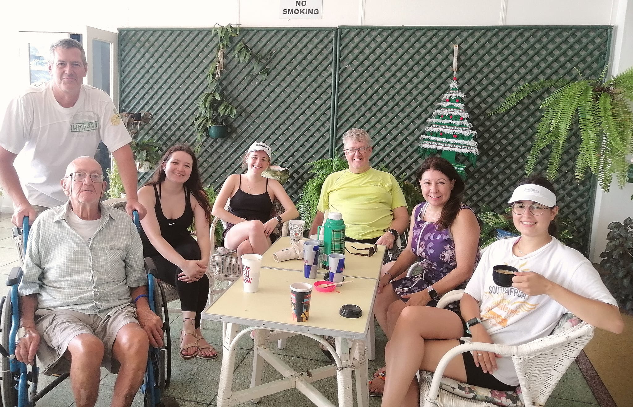 Family visiting a resident on the verandah at Edenroc Retirement Home